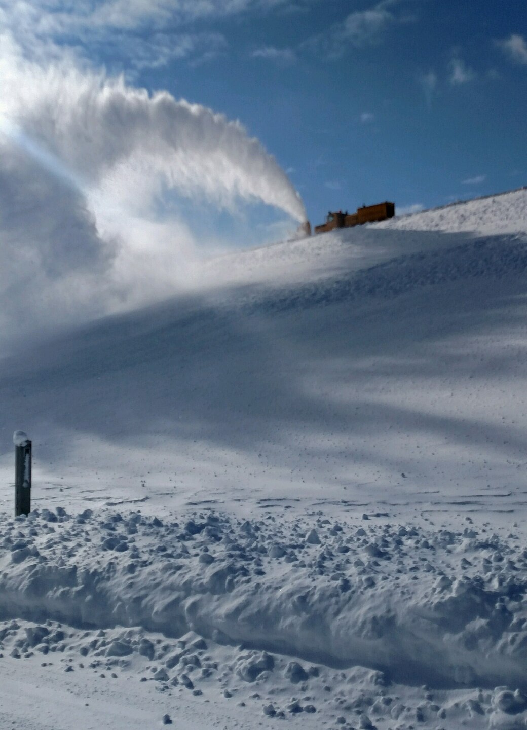 The big Oshkosh, driven by Corps Employee Chris Olson does its job blowing snow in an effort in cleaning up Crest Road. 