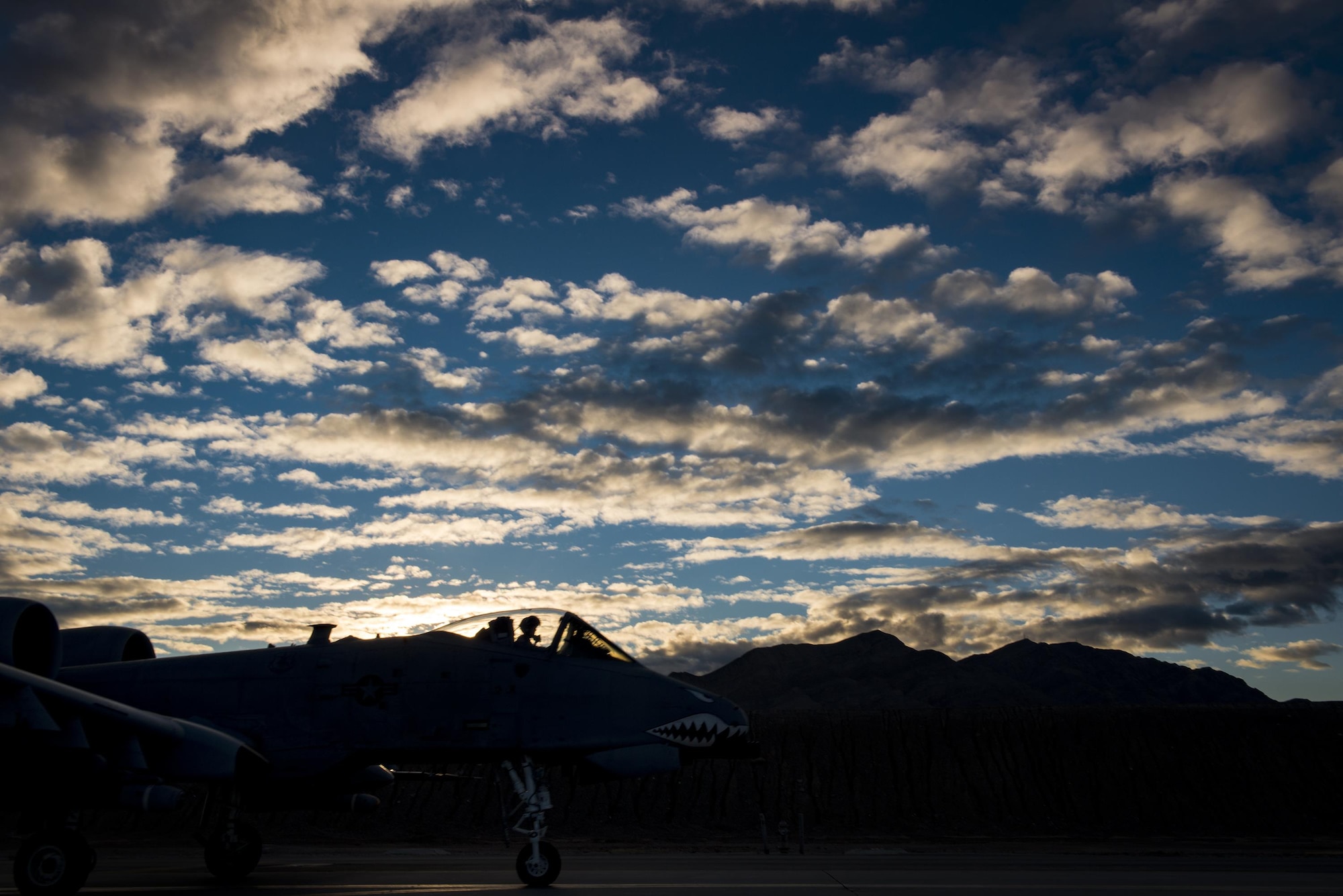 An A-10C Thunderbolt II from the 74th Fighter Squadron blends into a mountain range as it taxis toward the runway during Green Flag-West 17-03, Jan. 24, 2017, at Nellis Air Force Base, Nev. The 74th FS brought 12 A-10s to GFW in support of a joint, large-force combat-readiness exercise for close air support integration training. (U.S. Air Force photo by Staff Sgt. Ryan Callaghan)