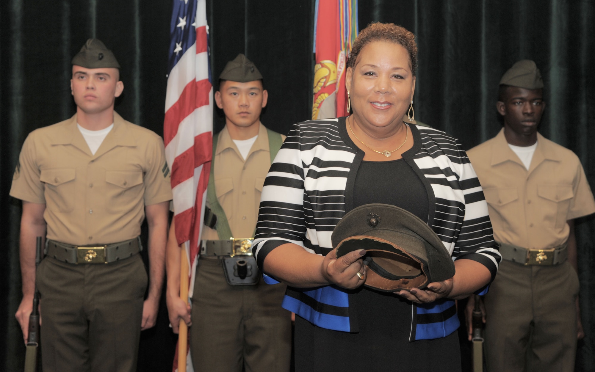 Kim Fountaine, daughter of U.S. Marine Corps Pfc. Charles Robert Fountain, a Montford Point Marine and WWII veteran, pauses for a photo with her father’s hat during a Congressional Gold Medal ceremony at MacDill Air Force Base, Fla., Jan. 27, 2017. Fountaine accepted the medal on behalf of her father. (U.S. Air Force photo by Airman 1st Class Adam R. Shanks)