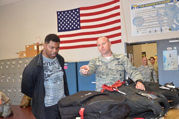 NFL football hero Herschel Walker visited Patrick Air Force Base, January 24, taking  time to meet with Guardian Angel Airmen from the 920th Rescue Wing. These elite warrior Airmen undergo intense physical and mental training to rescue isolated personnel in combat. They toured Walker through their squadron and demonstrated some of their rescue skills. Throughout the visit, Walker held their rapt attention sharing lots of inspirational accounts of his days playing football. Later that afternoon, Walker stood in front of several hundred Patrick AFB employees who came to listen to his personal battled with mental illness. (U.S. Air Force photo/Maj. Cathleen Snow)
