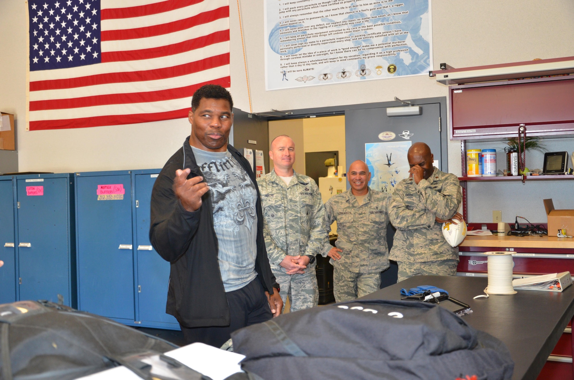 NFL football hero Herschel Walker visited Patrick Air Force Base, January 24, taking  time to meet with Guardian Angel Airmen from the 920th Rescue Wing. These elite warrior Airmen undergo intense physical and mental training to rescue isolated personnel in combat. They toured Walker through their squadron and demonstrated some of their rescue skills. Throughout the visit, Walker held their rapt attention sharing lots of inspirational accounts of his days playing football. Later that afternoon, Walker stood in front of several hundred Patrick AFB employees who came to listen to his personal battled with mental illness. (U.S. Air Force photo/Maj. Cathleen Snow)
