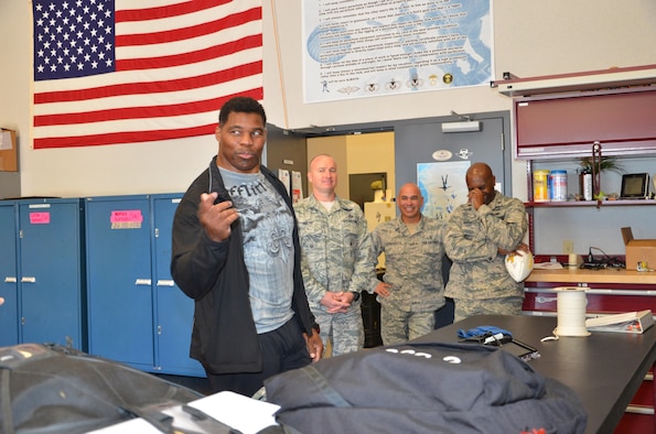 NFL football hero Herschel Walker visited Patrick Air Force Base, January 24, taking  time to meet with Guardian Angel Airmen from the 920th Rescue Wing. These elite warrior Airmen undergo intense physical and mental training to rescue isolated personnel in combat. They toured Walker through their squadron and demonstrated some of their rescue skills. Throughout the visit, Walker held their rapt attention sharing lots of inspirational accounts of his days playing football. Later that afternoon, Walker stood in front of several hundred Patrick AFB employees who came to listen to his personal battled with mental illness. (U.S. Air Force photo/Maj. Cathleen Snow)
