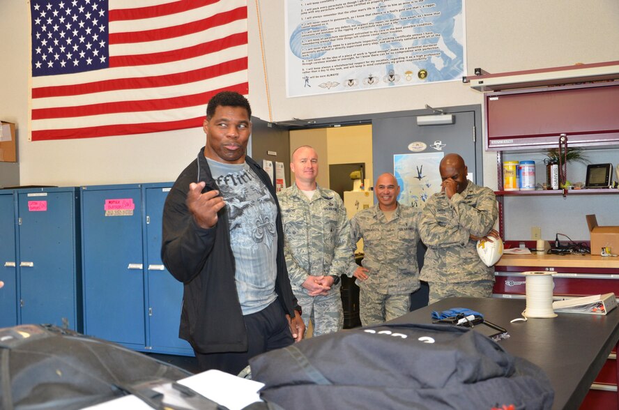 NFL football hero Herschel Walker visited Patrick Air Force Base, January 24, taking  time to meet with Guardian Angel Airmen from the 920th Rescue Wing. These elite warrior Airmen undergo intense physical and mental training to rescue isolated personnel in combat. They toured Walker through their squadron and demonstrated some of their rescue skills. Throughout the visit, Walker held their rapt attention sharing lots of inspirational accounts of his days playing football. Later that afternoon, Walker stood in front of several hundred Patrick AFB employees who came to listen to his personal battled with mental illness. (U.S. Air Force photo/Maj. Cathleen Snow)
