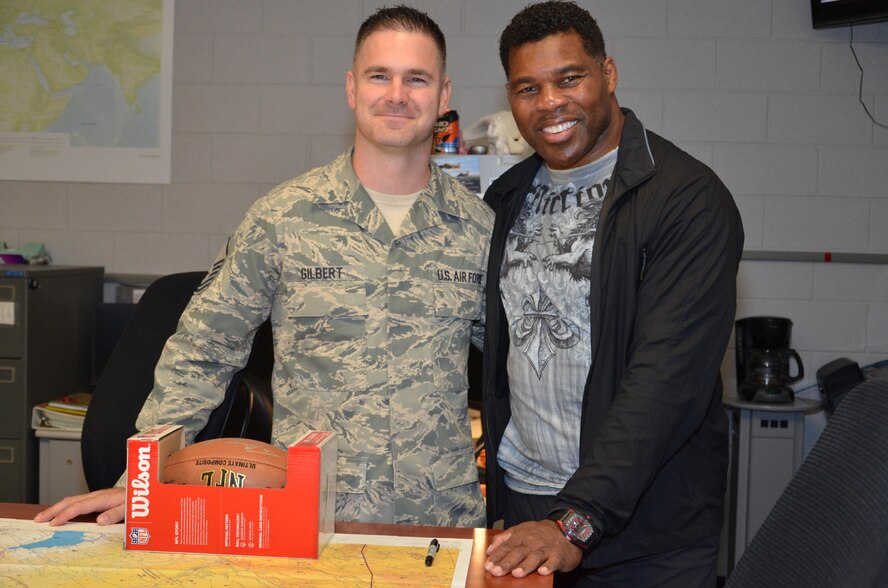 NFL football hero Herschel Walker visited Patrick Air Force Base, January 24, taking  time to meet with Guardian Angel Airmen from the 920th Rescue Wing. These elite warrior Airmen undergo intense physical and mental training to rescue isolated personnel in combat. They toured Walker through their squadron and demonstrated some of their rescue skills. Throughout the visit, Walker held their rapt attention sharing lots of inspirational accounts of his days playing football. Later that afternoon, Walker stood in front of several hundred Patrick AFB employees who came to listen to his personal battled with mental illness. (U.S. Air Force photo/Maj. Cathleen Snow)
