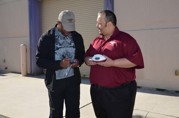 NFL football hero Herschel Walker visited Patrick Air Force Base, January 24, taking  time to meet with Guardian Angel Airmen from the 920th Rescue Wing. These elite warrior Airmen undergo intense physical and mental training to rescue isolated personnel in combat. They toured Walker through their squadron and demonstrated some of their rescue skills. Throughout the visit, Walker held their rapt attention sharing lots of inspirational accounts of his days playing football. Later that afternoon, Walker stood in front of several hundred Patrick AFB employees who came to listen to his personal battled with mental illness. (U.S. Air Force photo/Maj. Cathleen Snow)
