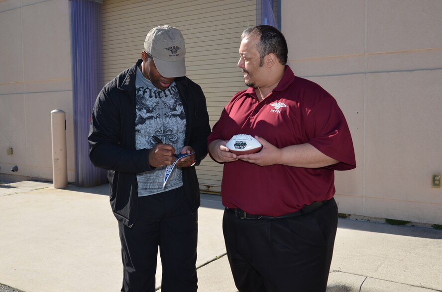 NFL football hero Herschel Walker visited Patrick Air Force Base, January 24, taking  time to meet with Guardian Angel Airmen from the 920th Rescue Wing. These elite warrior Airmen undergo intense physical and mental training to rescue isolated personnel in combat. They toured Walker through their squadron and demonstrated some of their rescue skills. Throughout the visit, Walker held their rapt attention sharing lots of inspirational accounts of his days playing football. Later that afternoon, Walker stood in front of several hundred Patrick AFB employees who came to listen to his personal battled with mental illness. (U.S. Air Force photo/Maj. Cathleen Snow)
