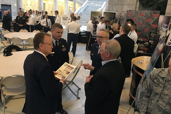 Utah Senator Stuart Adams (right to left), speaks with Col. Todd Murphey 419th Fighter Wing vice commander, Chief Master Sgt. Don Stroud, 388th Fighter Wing command chief, and Jim Hutto, 75th Air Base Wing legislative liaison, Jan. 26 at the Utah State Capitol Rotunda during the Utah Defense Alliance ‘Meet the Military’ event with Utah legislature. (U.S. Air Force photo by Donovan Potter)