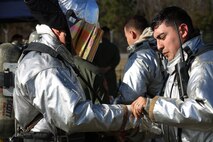 Cpl. Noah Rios adjusts Sgt. Maj. Charles Metzger’s gear during a live fire training event on Marine Corps Air Station New River, N.C., Jan. 19, 2017. The training used propane and piping to simulate fires on the interior and exterior of an aircraft. Rios is a rescueman with Marine Corps Air Station New River’s Aircraft Rescue Firefighting division. Metzger is the air station’s sergeant major. (U.S. Marine Corps photo by Cpl. Melodie Snarr)