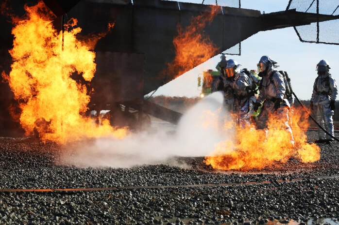 Col. Russell Burton and Sgt. Maj. Charles Metzger work to extinguish a fire during a live fire training event on Marine Corps Air Station New River, N.C., Jan. 19, 2017. There was an estimated 9,000 gallons of water with the Marines during the training. Burton is the air station’s commanding officer. Metzger is the air station’s sergeant major. (U.S. Marine Corps photo by Cpl. Melodie Snarr)