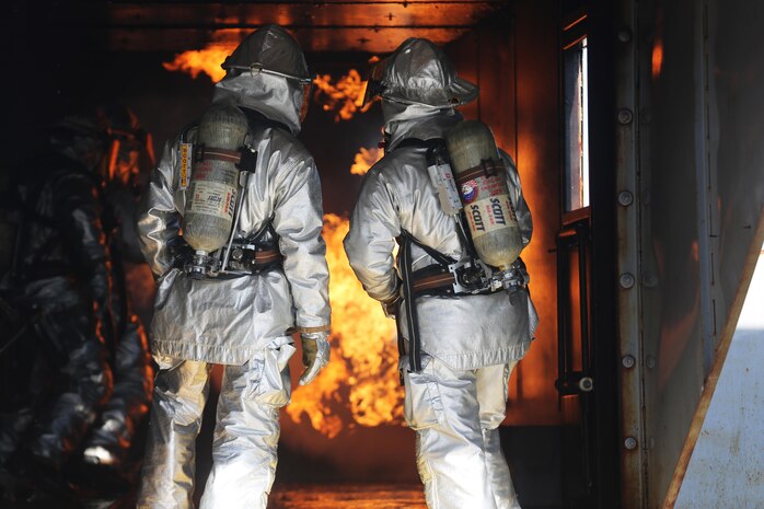 Cpl. Noah Rios Cpl. Caden Vanbuskirk monitor the other rescuemen to ensure they are safe and conducting the training properly during a live fire training event on Marine Corps Air Station New River, N.C., Jan. 19, 2017. While doing training, the Marines keep enough water with them for the training and for an emergency. Rios and Vanbuskirk are rescuemen with Marine Corps Air Station New River’s Aircraft Rescue Firefighting division. (U.S. Marine Corps photo by Cpl. Melodie Snarr)