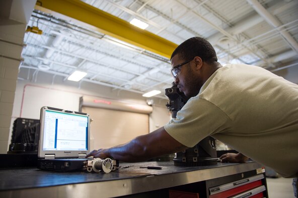 Staff Sgt. Disraeli Lee, an armament team chief with the 1st Special Operations Maintenance Squadron, looks over a technical order for installing a safety wire on a 25 mm Gatling gun at Hurlburt Field, Fla., Jan. 25, 2017. A technical order is a step-by-step instruction used for maintenance repairs and inspections. (U.S. Air Force photo by Senior Airman Krystal M. Garrett)