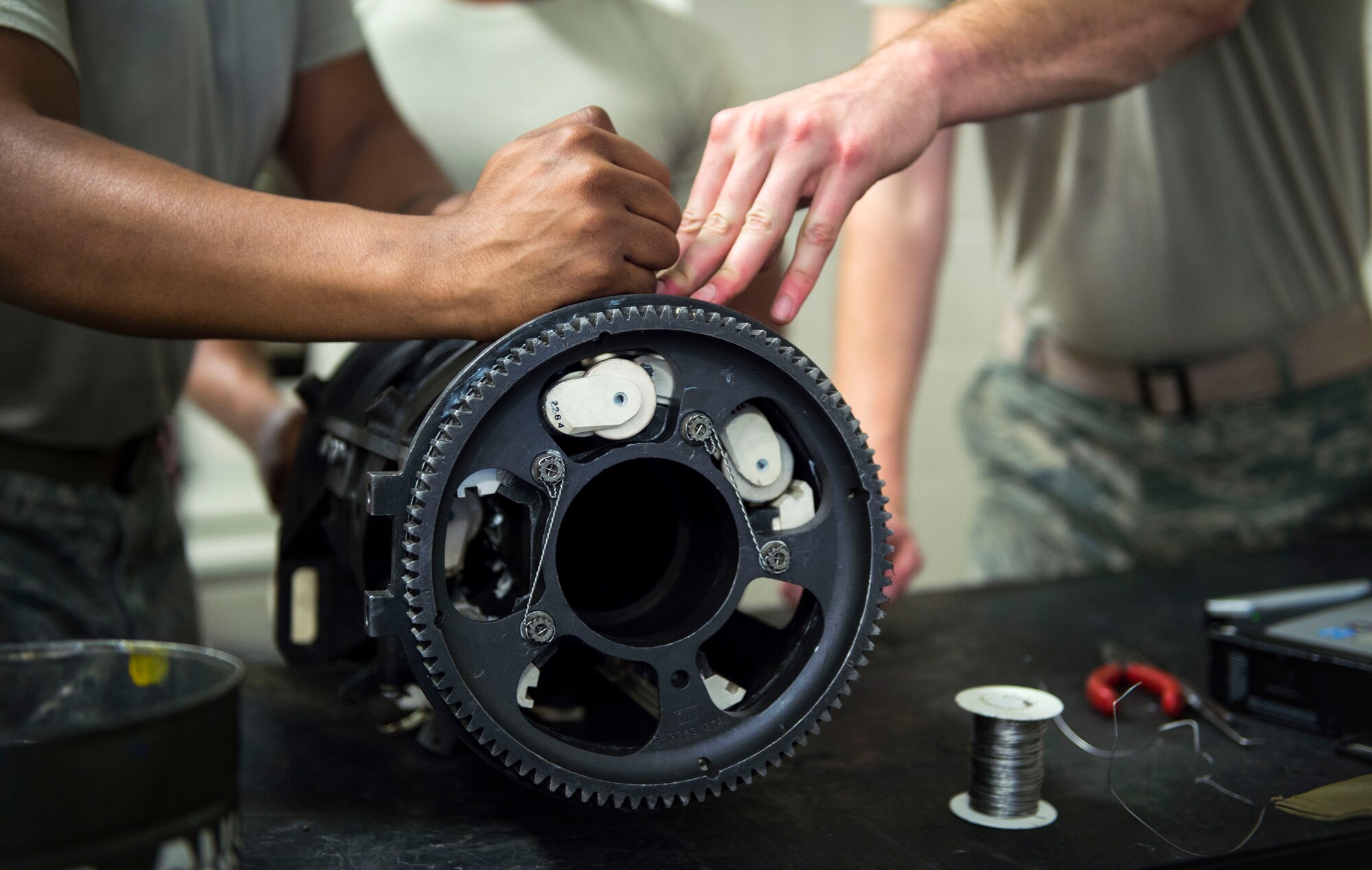 Armament Airmen with the 1st Special Operations Maintenance Squadron perform a five-round check on a 25 mm Gatling gun at Hurlburt Field, Fla., Jan. 25, 2017. Five-round checks consist of placing cut off barrels into the gun chamber and rotating rounds to ensure they extract. These checks are performed to ensure all components of the Gatling gun are working properly. (U.S. Air Force photo by Senior Airman Krystal M. Garrett)