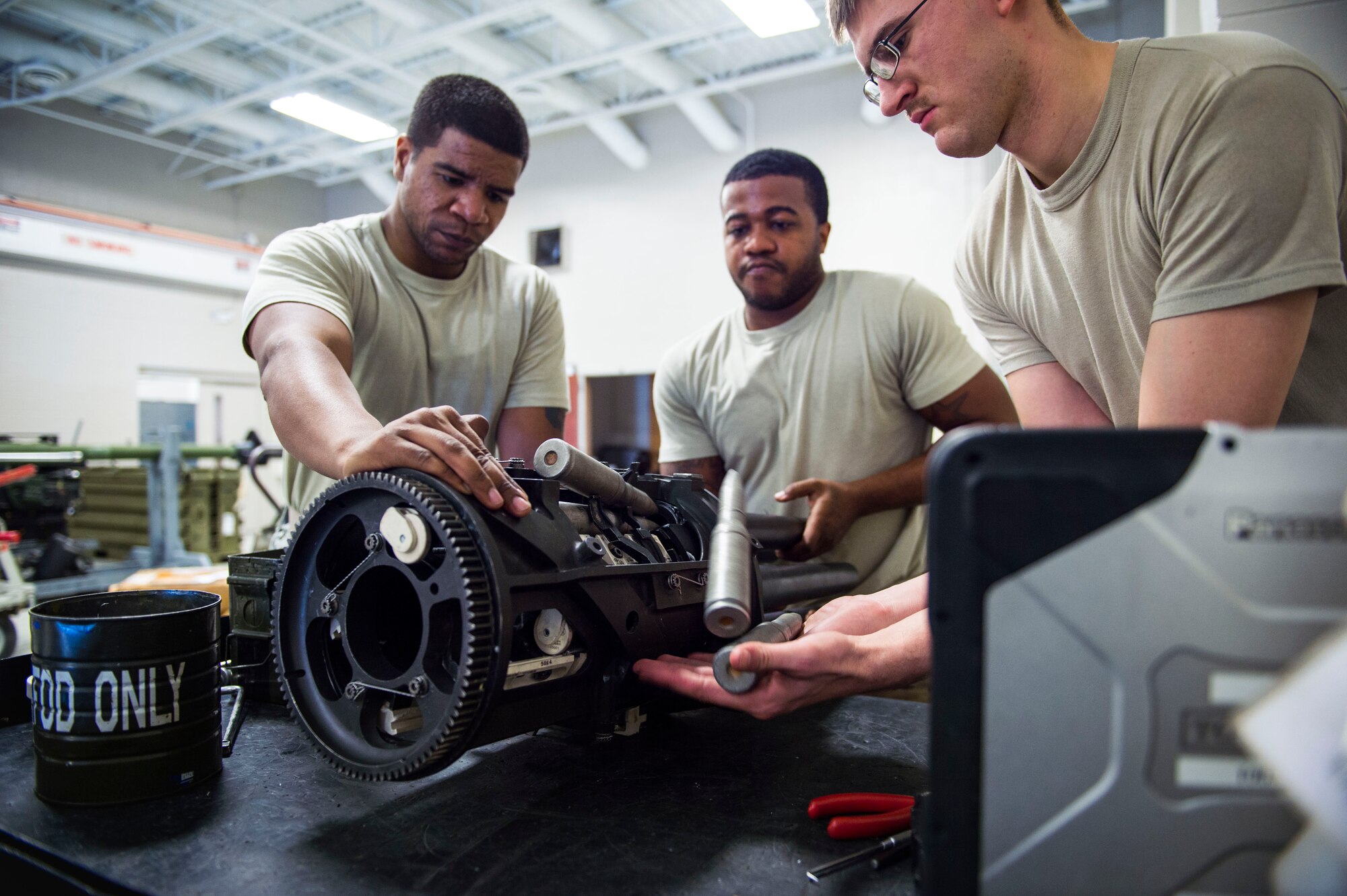Armament Airmen with the 1st Special Operations Maintenance Squadron perform a five-round check on a 25 mm Gatling gun at Hurlburt Field, Fla., Jan. 25, 2017. Five-round checks consist of placing cut off barrels into the gun chamber and rotating rounds to ensure they extract. These checks are performed to ensure all components of the Gatling gun are working properly. (U.S. Air Force photo by Senior Airman Krystal M. Garrett)