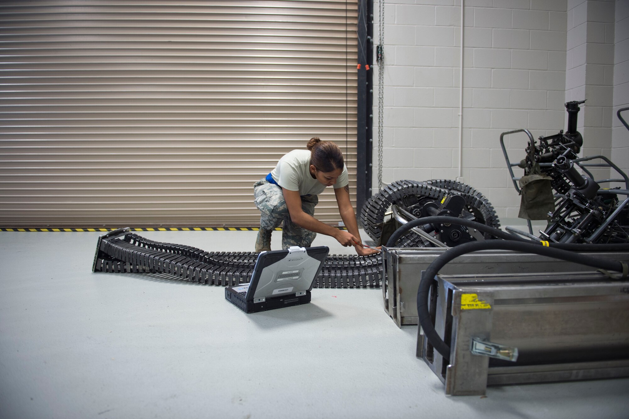 Senior Airman Kayla Ross, an armament journeyman with the 1st Special Operations Maintenance Squadron, performs a 30-day inspection on an ammunition loading system at Hurlburt Field, Fla., Jan. 25, 2017. Ross checked to ensure the system was aligned so rounds won’t get caught in the load transfer cartridge when firing. (U.S. Air Force photo by Senior Krystal M. Garrett) 