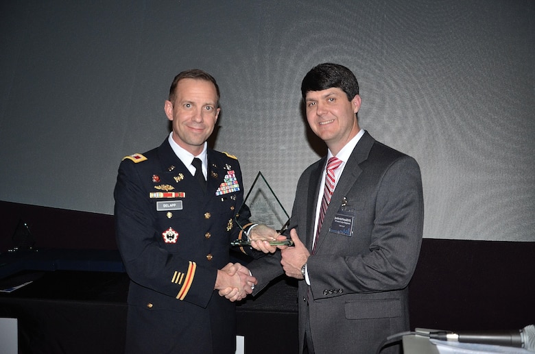 Justin McDonald (Right), lead engineer for USACE Mobile Civil Works, accepts the 2017 Mobile Area Council of Engineers (MACE) ‘Young Engineer of the Year’ award from District Commander Col. James DeLapp Jan. 26 at the Gulf Coast Exploreum Science Center in Mobile, Ala. The award is handed out to an engineer who is under the age of 35 and who demonstrates leadership in their professional lives and in the community. 