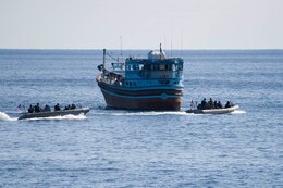 Two rigid-hull inflatable boats, attached to the Arleigh Burke-class guided-missile destroyer USS Cole (DDG 67), approach an Iranian-flagged dhow during an approach and assist visit. Cole is deployed in the U.S. 5th Fleet area of operations in support of maritime security operations and theater security cooperation efforts.