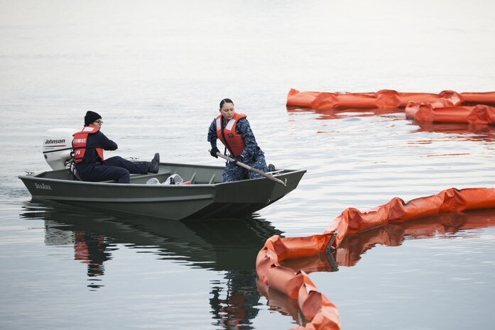 U.S. Navy Engineman 3rd Class Elizabeth Rodriguez, left, and U.S. Navy Engineman 3rd Class Yajaira Armenta Navarro, right, with harbor operations work together to retrieve a boom during a spill training exercise at Marine Corps Air Station Iwakuni, Japan, Jan. 27, 2017. The boom is used during spills to corral oil and fuel into controlled areas. The air station conducts an annual spill training exercise to evaluate response time, efficiency and to prepare for any spills that may occur. (U.S. Marine Corps photo by Lance Cpl. Joseph Abrego)