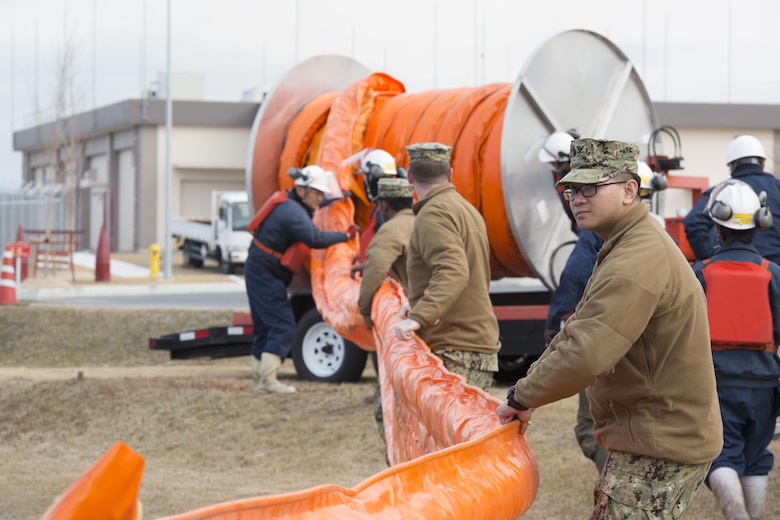 U.S. Sailors and facilities personnel respond to a simulated spill during a spill training exercise at Marine Corps Air Station Iwakuni, Japan, Jan. 27, 2017. The air station conducts an annual spill training exercise to evaluate response time, efficiency and to prepare for any spills that may occur. (U.S. Marine Corps photo by Lance Cpl. Joseph Abrego)