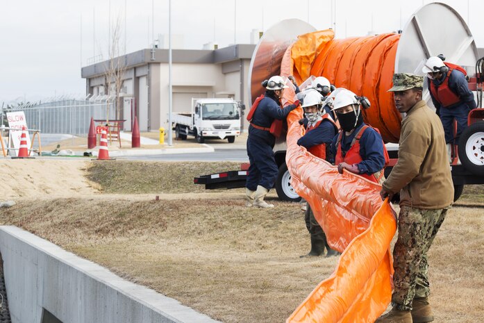 U.S. Sailors and facilities personnel respond to a simulated spill during a spill training exercise at Marine Corps Air Station Iwakuni, Japan, Jan. 27, 2017. The air station conducts an annual spill training exercise to evaluate response time, efficiency and to prepare for any spills that may occur. (U.S. Marine Corps photo by Lance Cpl. Joseph Abrego)