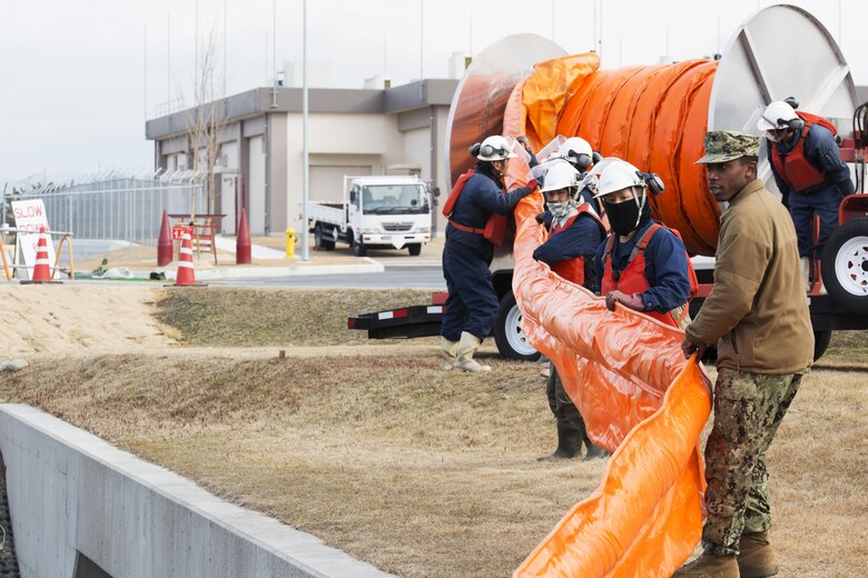 U.S. Sailors and facilities personnel respond to a simulated spill during a spill training exercise at Marine Corps Air Station Iwakuni, Japan, Jan. 27, 2017. The air station conducts an annual spill training exercise to evaluate response time, efficiency and to prepare for any spills that may occur. (U.S. Marine Corps photo by Lance Cpl. Joseph Abrego)