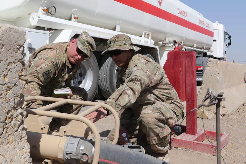 Maj. William Rozar, the deputy Inspector General for the 1st Theater Sustainment Command Operational Command Post, and 1st Lt. Brian Mutas, the petroleum operations officer for the Nevada National Guard’s 17th Sustainment Brigade, inspect the fuel gauge on a tanker truck downloading fuel at a forward operating base in Iraq, recently. U.S. Army Central uses forward logistical elements to maintain fuel farms under contract with U.S. Army logistical specialists called contract representatives to ensure the operations is being conducted to the Army standard. (U.S. Army photo by Sgt. Brandon Hubbard, USARCENT Public Affairs)