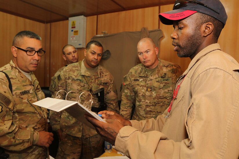 Master Sgt. Jose Torres, from left, and Sgt. Jose Irizarry, petroleum specialists from the 969th Quartermaster Company, and Maj. William Rozar, the deputy Inspector General for the 1st Theater Sustainment-Command Operational Command Post, review daily records at a fuel farm in Iraq, which are maintained by Department of Defense contract workers. (U.S. Army photo by Sgt. Brandon Hubbard, USARCENT Public Affairs)