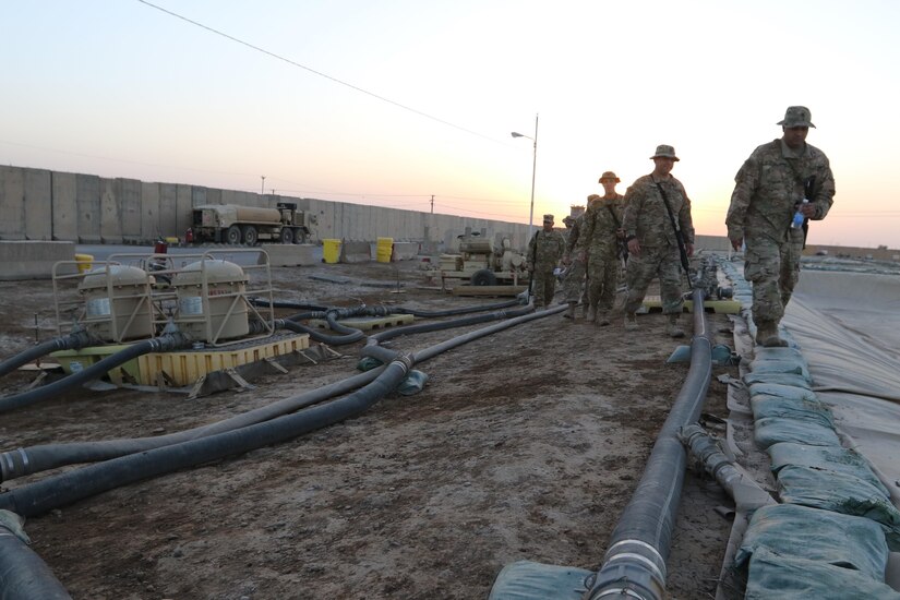 Inspectors General from the 1st Theater Sustainment Command-Operational Command Post and petroleum specialists from Task Force Phoenix walk the fuel lines at a forward operating base in central Iraq to inspect the operations, recently. The 1st TSC is responsible for overseeing fuel logistics in multiple countries throughout Southwest Asia. (U.S. Army photo by Sgt. Brandon Hubbard, USARCENT Public Affairs)