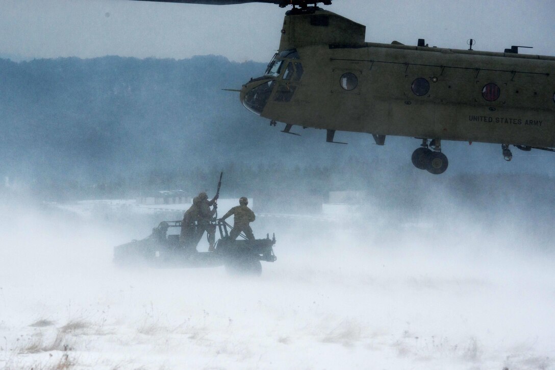 Soldiers prepare to hookup a Humvee to a CH-47 Chinook helicopter during slingload training at the Baumholder Military Training Area in Baumholder, Germany, Jan. 26, 2017. Army photo by Erich Backes