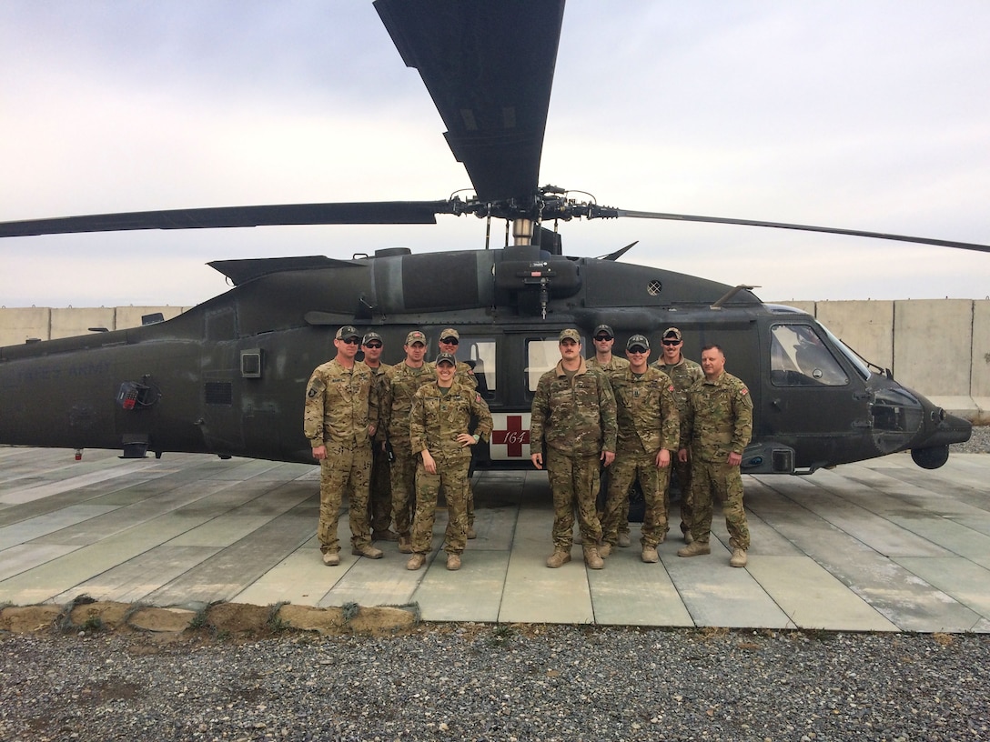 FORWARD OPERATING BASE DAHLKE, Afghanistan - The Task Force Gunfighters, Charlie Company, 2nd General Support Aviation Battalion, 1st Aviation Regiment,, 1st Infantry Division Combat Aviation Brigade, pilots and crew members of Team Chapman DUSTOFF.  U.S. Army Sgt. Michael Charles (second from left), Staff Sgt. Trevor Thompson (fourth from right) and Capt. Cody Sneed (third from right) were recently awarded The Air Medal for their extraordinary efforts in the medical evacuation that saved the life of a Afghan National Army Soldier gravely wounded in a combat fire fight.  Also pictured from left, Chief Warrant Officer 2 Craig Bakies, Chief Warrant Officer 2 Matthew Seiber, Staff Sgt. Kathryn Asurmendi, Sgt. Joshua Steveson, Spc. Justin Couvitier, Sgt. Chad Carmichael, and Chief Warrant Officer 3 Kerry Hall.  DUSTOFF is an commonly used, traditional acronym for helicopter medical evacuation: Dedicated Unhesitating Service To Our Fighting Forces.  (Photo courtesy U.S. Army Capt. Cody Sneed, 2-1 GSAB)