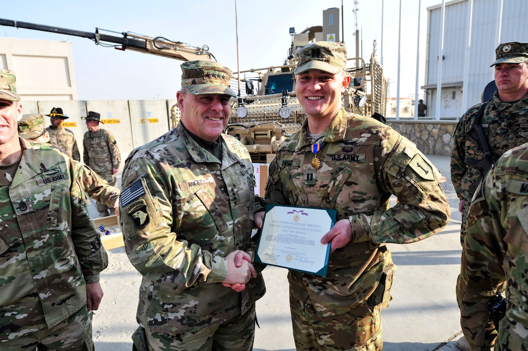BAGRAM AIRFIELD, Afghanistan (Dec. 18, 2016) - Gen. Mark A. Milley presents the Air Medal to Capt. Cody Sneed during a ceremony held near the U.S. Forces Afghanistan headquarters here. Milley is the Chief of Staff of the U.S. Army, Sneed is a UH-60 Blackhawk MEDEVAC helicopter pilot who helped save the life of an Afghan National Army Soldier critically wounded during a Sept. 21 combat operation in Khost Province.  Also photographed is Sergeant Major of the Army Daniel A. Dailey.  (Photo by Bob Harrison, U.S. Forces Afghanistan Public Affairs)