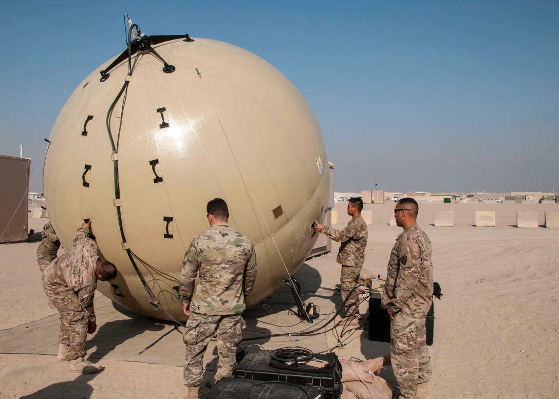 Signal Soldiers of the 369th Sustainment Brigade practice aligning a Ground Antenna Transmit Receive (GATR) Ball at Camp Arifjan, Kuwait on Jan. 10, 2017. The GATR Ball is a portable satellite communications system that can be deployed to remote areas in a relatively short amount of time. (U.S. Army photo by Sgt. Jeremy Bratt)