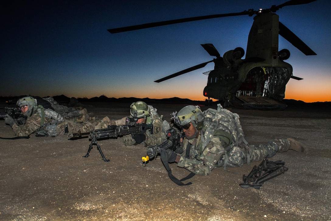 Soldiers establish a defensive perimeter around a CH-47 Chinook helicopter during an air assault training exercise at the National Training Center, Fort Irwin, Calif., Jan. 25, 2017. Army photo by Pvt. Austin Anyzeski