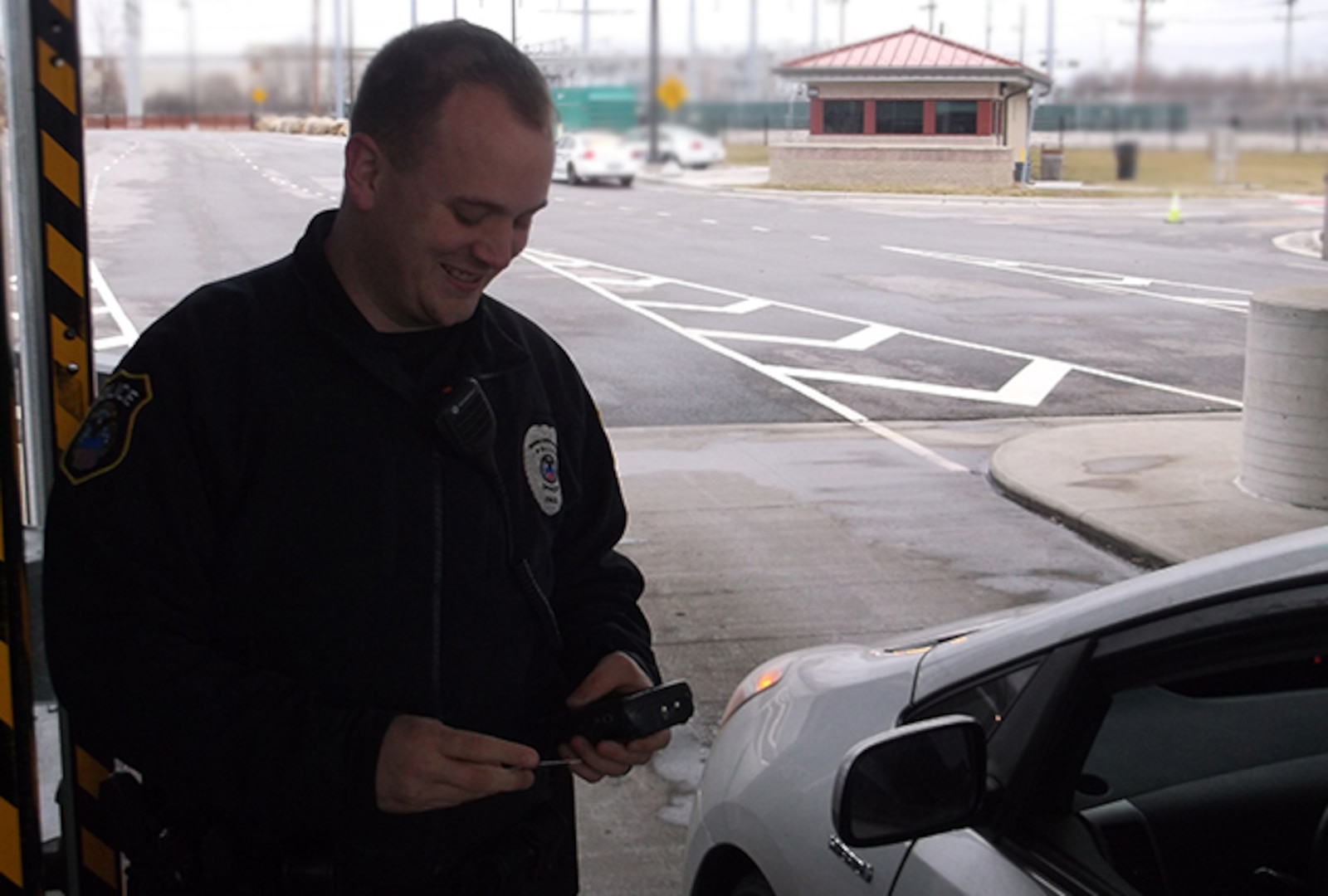 Officer David Webb, Defense Supply Center Columbus, police officer performs ID checks of incoming traffic at Yearling Road gate.