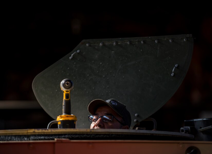 Pablo Flores, an installer and instructor for the Materiel Fielding & Training Team, prepares a turret to install a Common Remotely Operated Weapon Station (CROWS), at Fort Chaffee, Arkansas, Jan. 26. The CROWS is a remote-controlled system compatible with four major crew-serve weapons, and it was developed to keep gunners safe within the vehicle while engaging enemy targets. (U.S. Army Reserve photo by Master Sgt. Michel Sauret)