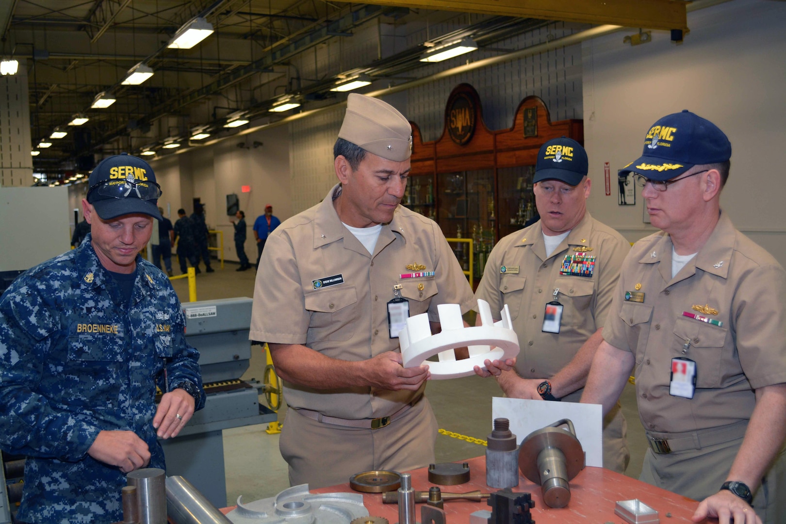Machinery Repair Technician Chief Jason Broenneke, Capt. Dave Gombas and Lt. Cmdr. Keith Foster show examples of fabricated shipboard materiel to Rear Adm. Stephen F. Williamson. The examples were all fabricated by Sailors at Southeast Regional Maintenance Center (SERMC).  Rear Adm. Williamson toured the different production lines, shops and labs present at SERMC.