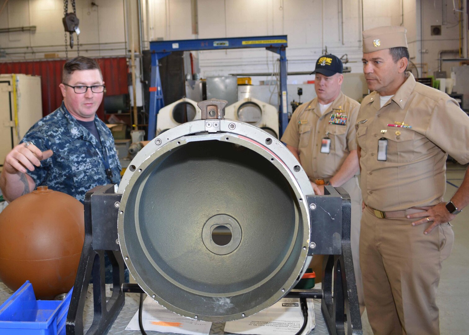 Machinist’s Mate 1st Class Earl Riggs discusses some of the maintenance involved with torpedo tubes at Southeast Regional Maintenance Center (SERMC). Williamson served as the Combat Systems Repair Officer at SERMC during a previous tour of duty. 