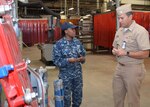 Damage Controlman 1st Class Fungai Diura explains to Rear Adm. Stephen F. Williamson how damaged watertight doors are repaired at Southeast Regional Maintenance Center. Rear Adm. Williamson is the Director for Fleet Maintenance, United States Pacific Fleet. 