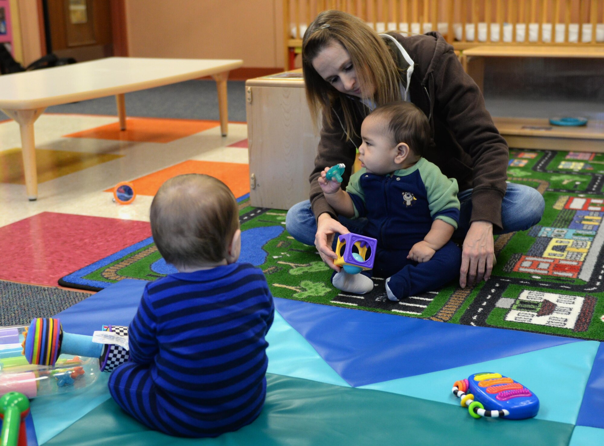 Michelle Caslin, the Child Development Center program lead, interacts with children Jan. 26, 2017, at the CDC on Little Rock Air Force Base, Ark. The CDC’s goal is to support each child's needs and abilities and challenge them to reach their individual potential. (U.S. Air Force photo by Airman 1st Class Codie Collins)