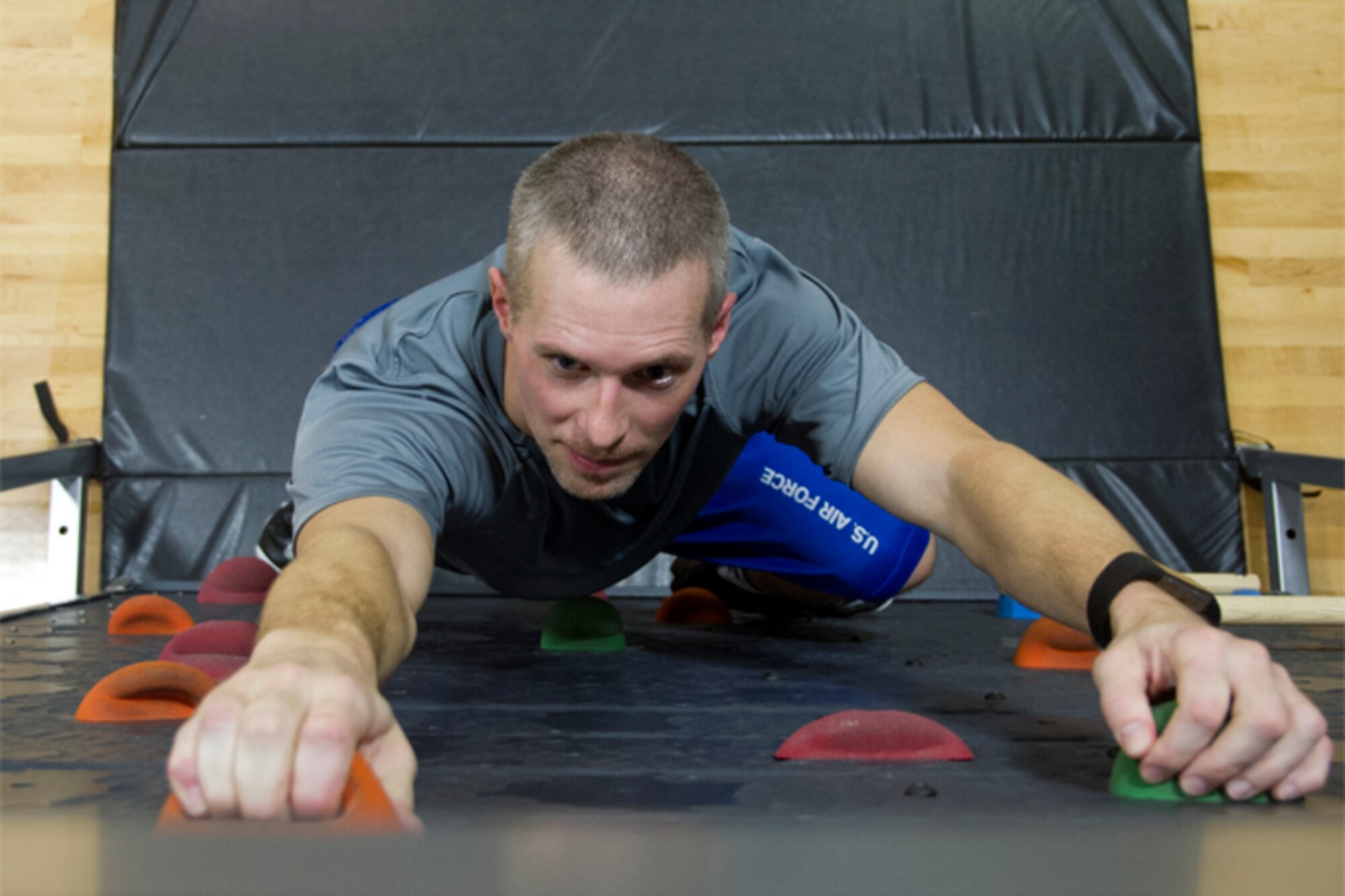 Cory "Silver Fox" Walters, 434th Civil Engineer Squadron biological scientist, climbs the new rock climbing wall in the gym at Grissom Air Reserve Base, Ind., Jan. 25, 2017. The gym offers a variety of workout equipment aimed at providing fun and engaging workout activities. (U.S. Air Force photo/Senior Airman Harrison Withrow