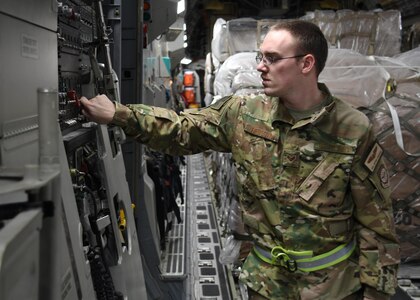U.S. Air Force Senior Airman Jefery Reagan, a loadmaster with the 816th Expeditionary Airlift Squadron, lowers the ramp on a C-17 Globemaster III at Al Udeid Air Base, Qatar, Dec. 23, 2016. As a loadmaster, Reagan distributes and straps down cargo on C-17 aircraft so it will be safe and secure while in flight. Although there are multiple mobility forces assigned to Air Forces Central, the 816th EAS is one of the closest 18th Air Force assigned units supporting the fight in Iraq and Syria.  (U.S. Air Force photo by Senior Airman Miles Wilson)