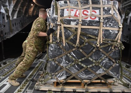 U.S. Air Force Staff Sgt. Cameron Morris, a loadmaster with the 816th Expeditionary Airlift Squadron, pushes a pallet into place on a C-17 Globemaster III at Al Udeid Air Base, Qatar, Dec. 23, 2016. Loadmasters ensure that the weight on an aircraft is distributed evenly, otherwise it could cause issues while in flight that may endanger the personnel. (U.S. Air Force photo by Senior Airman Miles Wilson)
