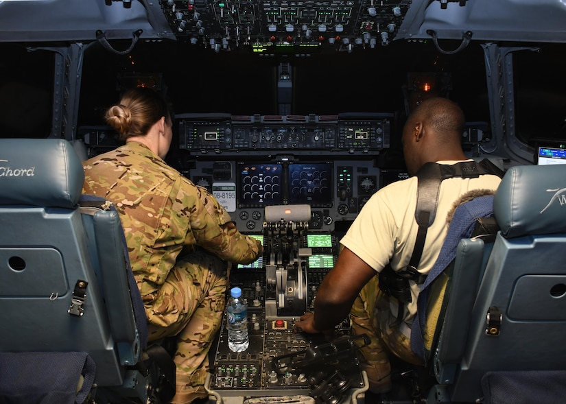 U.S. Air Force Capt. Brittany Bean, left, and U.S. Air Force 1st Lt. Wesley Cobb, right, C-17 Globemaster III pilots with the 816th Expeditionary Airlift Squadron, perform preflight checks at Al Udeid Air Base, Qatar, Dec. 23, 2016. The 816th EAS is one of the closest 18th Air Force assigned units supporting the fight in Iraq and Syria. As the only expeditionary squadron directly reporting to 18th AF, it draws on aircrews and maintainers from every C-17 unit to provide theater-direct delivery to the U.S. Central Command area of responsibility.  (U.S. Air Force photo by Senior Airman Miles Wilson)