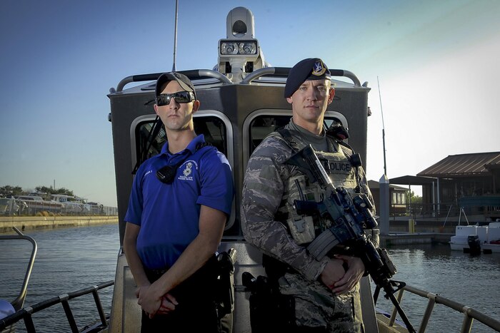 Air Force Senior Airmen Zade Becker, left, a marine patrolman assigned to the 6th Security Forces Squadron, and his brother Austin Becker, right, an emergency services team operator assigned to the 6th SFS, pose for a photo at MacDill Air Force Base, Fla., Dec. 14, 2016. The Becker brothers are currently stationed together at MacDill and defend the base as security forces members. Air Force photo by Airman 1st Class Mariette Adams