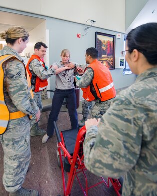 Service members from David Grant USAF Medical Center participate in an active shooter exercise at Travis Air Force Base, Calif., Jan. 26, 2017. The exercise evaluated the medical staff’s lock down response and patient care procedures. (U.S. Air Force photo/Louis Briscese)