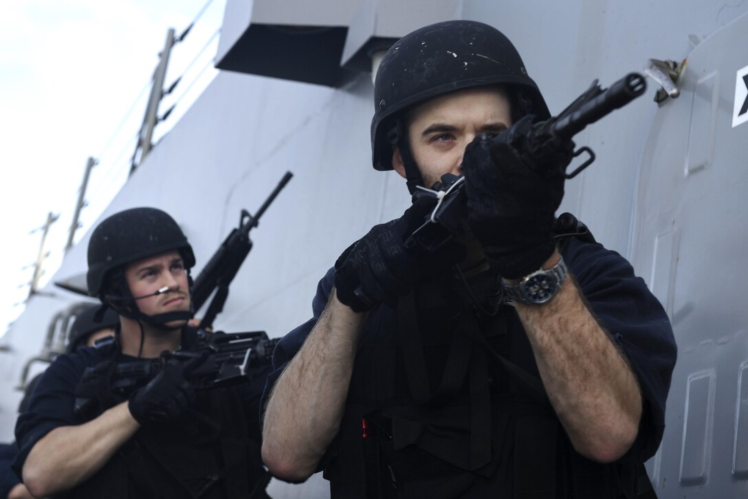 Navy Petty Officer 2nd Class Miguel Hernandez, foreground, and Navy Petty Officer 1st Class Matthew Gagne advance to a ladder during a visit, board, search-and-seizure drill aboard the Arleigh Burke-class guided-missile destroyer USS Wayne E. Meyer in the Pacific Ocean, Jan. 25, 2017. Hernandez is an electrician’s mate and Gagne is an information systems technician. Navy photo by Petty Officer 3rd Class Kelsey L. Adams