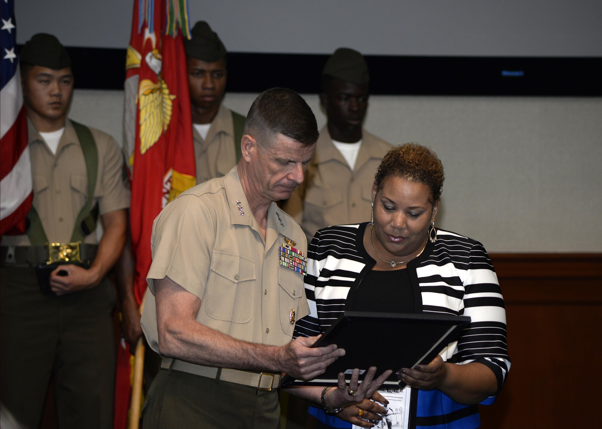 Kim Fountaine, right, accepts a certificate on behalf of her father, U.S. Marine Corps Pfc. Charles Robert Fountain, from Lt. Gen. William D. Beydler, commander of U.S. Marine Forces Central Command, during a Congressional Gold Medal ceremony at MacDill Air Force Base, Fla., Jan. 27, 2017. The certificate was awarded to Fountain who served in the Montford Point Marines, an all African-American unit that was segregated throughout World War II. (U.S. Air Force photo by Tech. Sgt. Krystie Martinez)