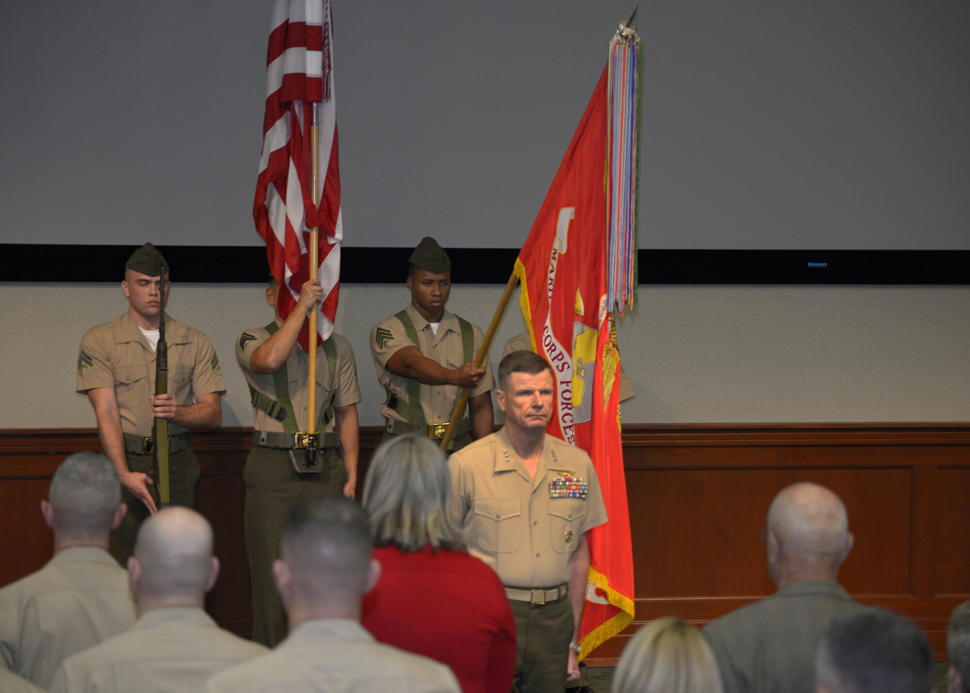 Service members rise for the presentation of the colors during a Congressional Gold Medal ceremony at MacDill Air Force Base, Fla., Jan. 27, 2017. The medal was awarded posthumously to a Montford Point Marine. This group of African-American Marines served while the military was still segregated during World War II. (U.S. Air Force photo by Tech. Sgt. Krystie Martinez)