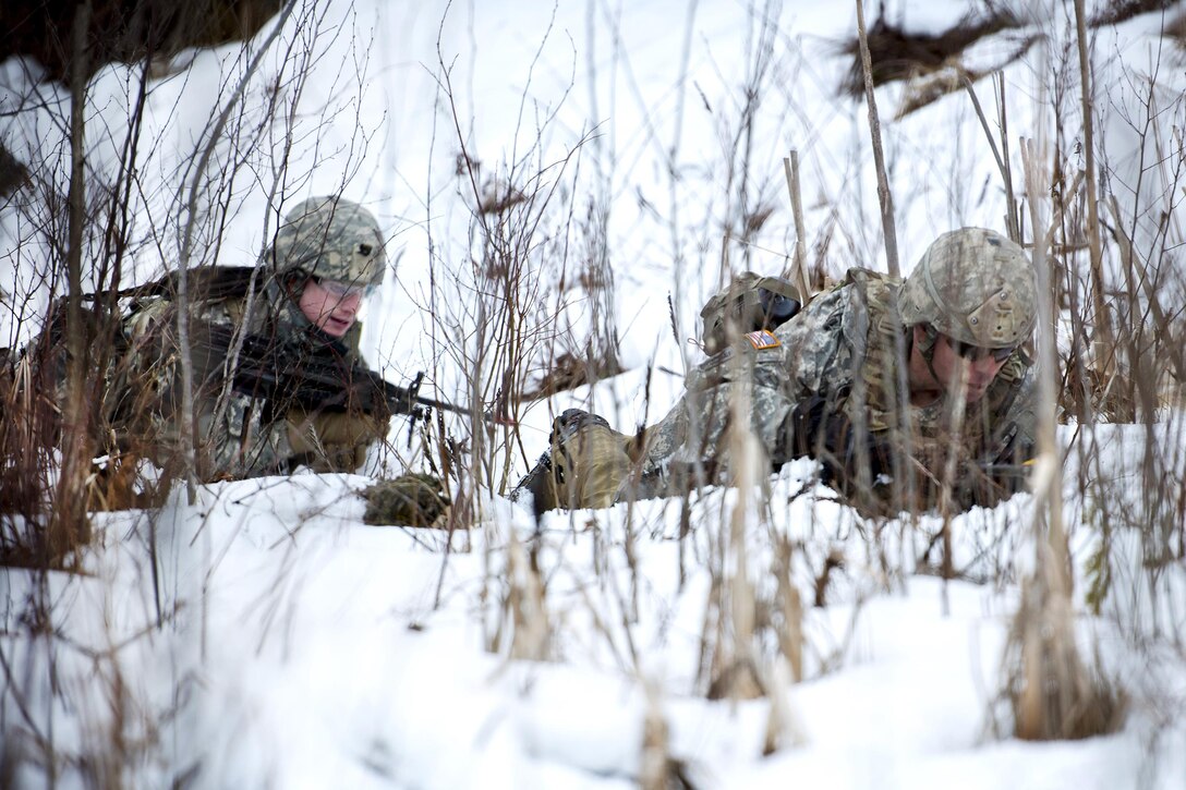 Army Spc. Forrest Watkins, left, and Staff Sgt. Steven Hernandez high crawl through the snow during ambush training at the Camp Ethan Allen Training Site, Jericho, Vt., Jan. 23, 2017. Watkins and Hernandez are assigned to the Vermont Army National Guard’s Company A, 3rd Battalion, 172nd Infantry Regiment, 86th Infantry Brigade Combat Team (Mountain). Air National Guard photo by Tech. Sgt. Sarah Mattison