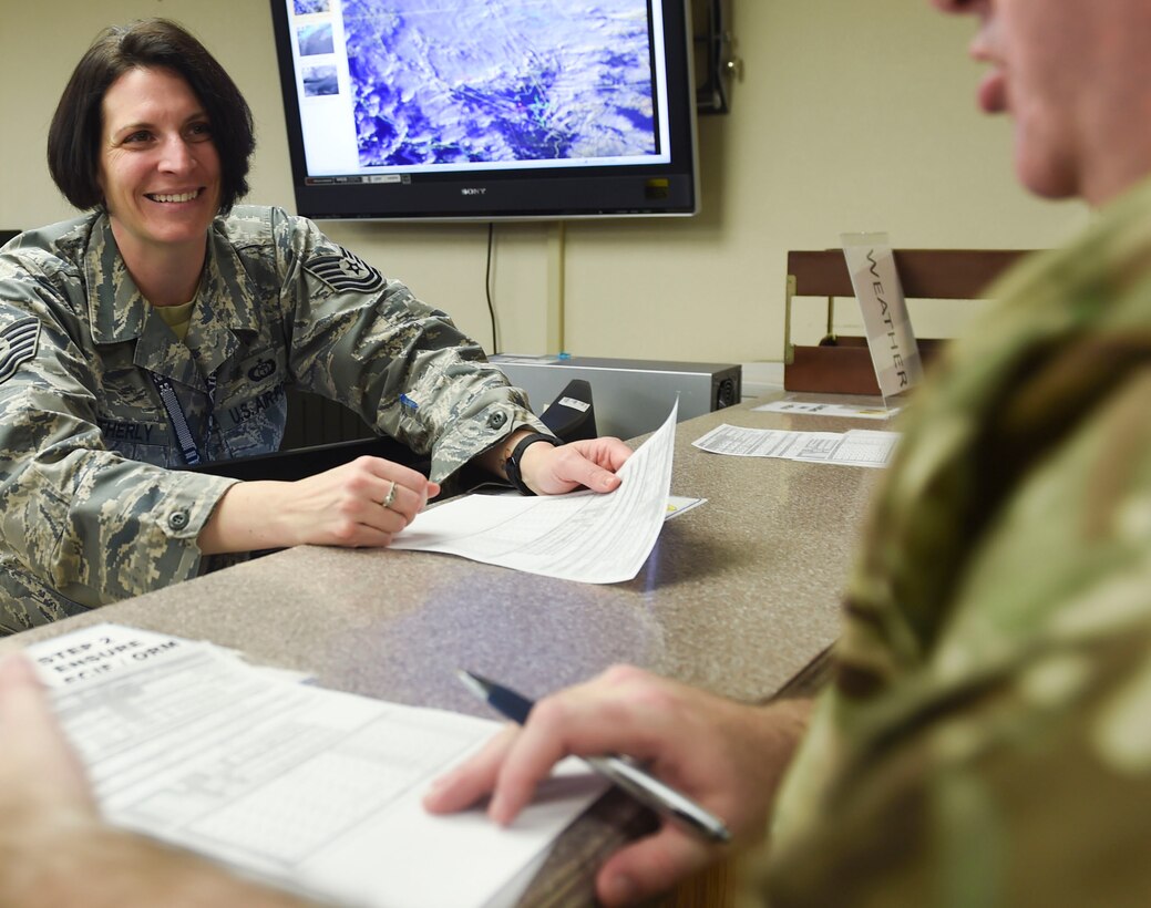 U.S. Air Force Tech. Sgt. Ashley Weatherly, Red Flag 17-1 weather forecaster from the 1st Operational Support Squadron at Joint Base Langley-Eustis, Va., answers a coalition partner’s questions about forecasts at Nellis Air Force Base, Nev., Jan. 23, 2017. The exercise’s weather forecasters prepare products that determine the ability to safely accomplish air-to-air combat training missions during the exercise. (U.S. Air Force photo by Staff Sgt. Natasha Stannard)