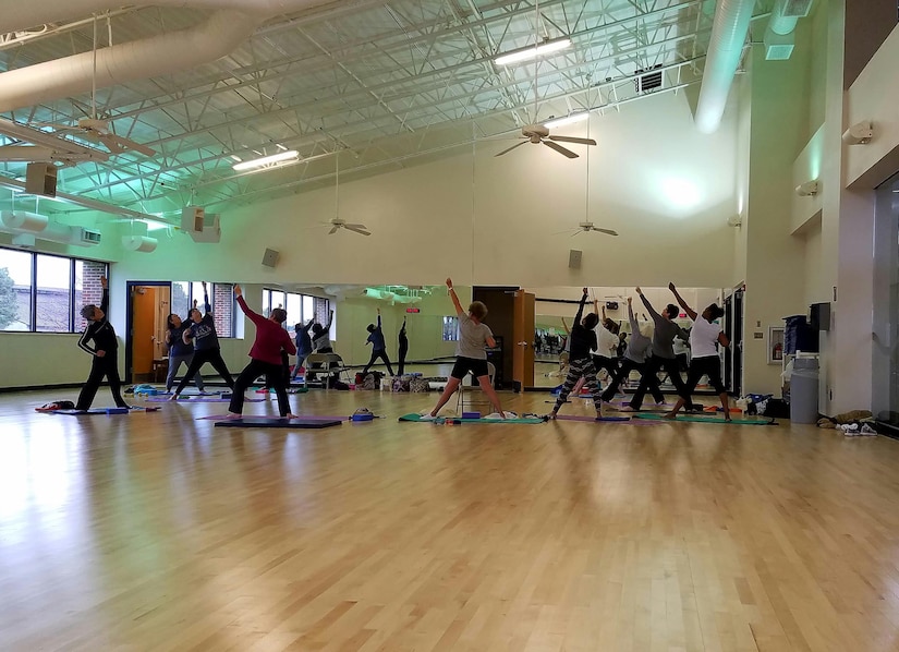 A yoga class is held in the Shellbank Fitness Center’s multipurpose exercise room at Joint Base Langley-Eustis, Va., Jan. 26, 2017. The room has reopened with new flooring and hosts fitness classes including yoga, step aerobics, stretch and tone, Zumba and body sculpting. When scheduled classes are not in session, the room is open to people who want to workout, however free weights and jump ropes are not allowed. (U.S. Air Force photo by Beverly Joyner)